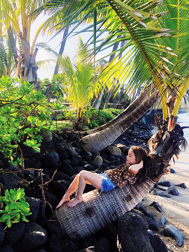 Maui with kids_child relaxing on palm tree